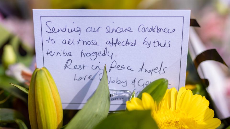 A bouquet of yellow flowers, with a message that reads: Sending our sincere condolences to all those affected by this terrible tragedy