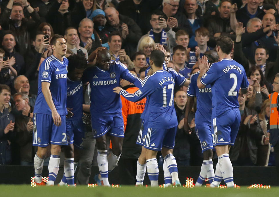 Chelsea's Demba Ba, third left, celebrates his goal against Tottenham Hotspur with teammates during their English Premier League soccer match at Stamford Bridge, London, Saturday, March 8, 2014. (AP Photo/Sang Tan)