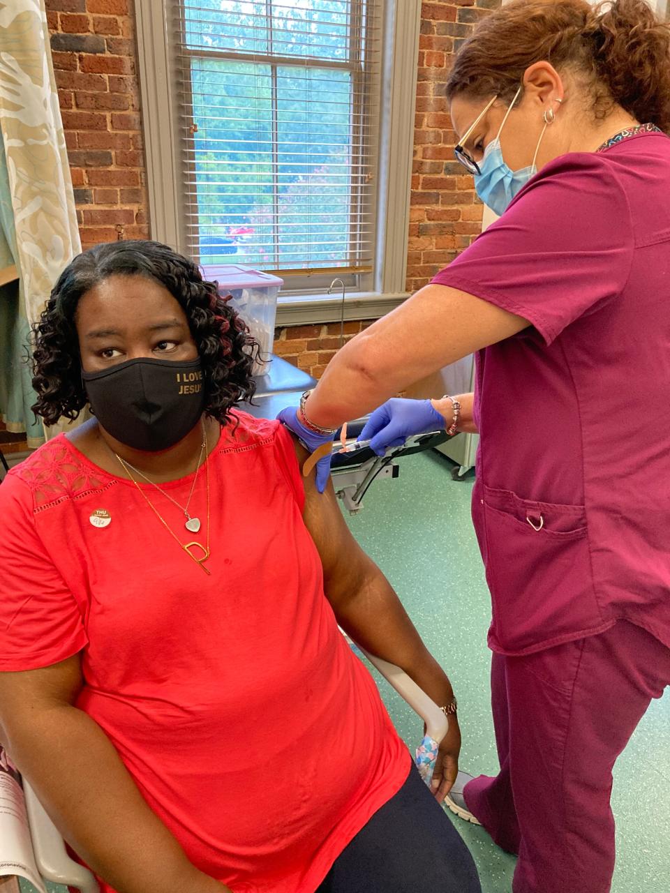 Pamela Dorsey of Augusta receives a COVID-19 vaccine booster shot from medical assistant Melissa Kelley at Christ Community Health Services, which is participating in the City of Augusta's vaccine incentive program.