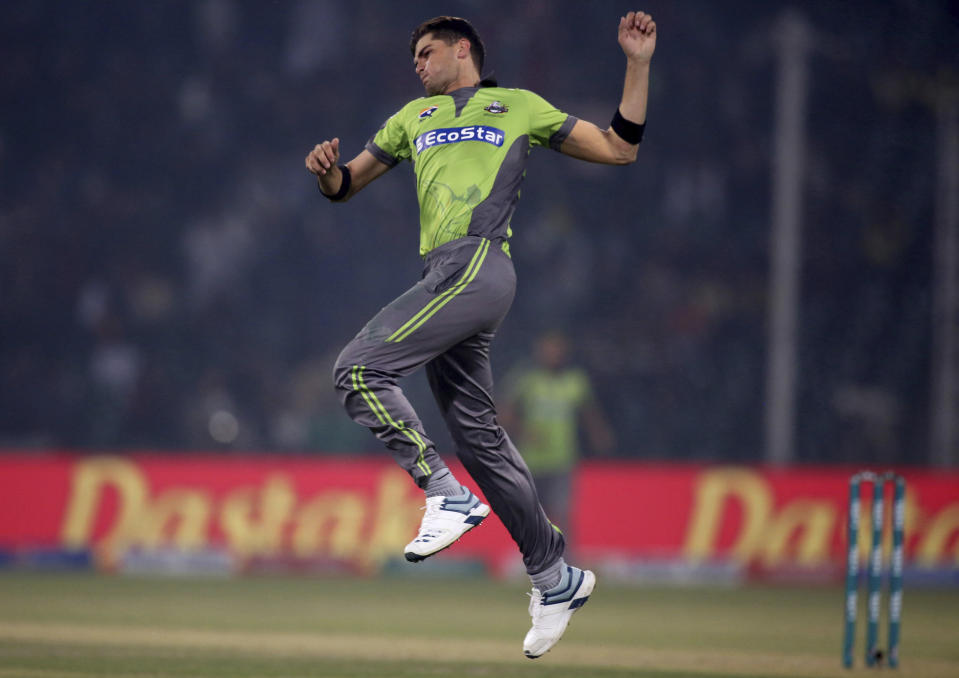 Lahore Qalandars pacer Shaheen Shah Afridi jumps to celebrate after taking the wicket of Islamabad United batsman Asif Ali during their Pakistan Super League T20 cricket match at Gaddafi stadium in Lahore, Pakistan, Sunday, Feb. 23, 2020. (AP Photo/K.M. Chaudary)