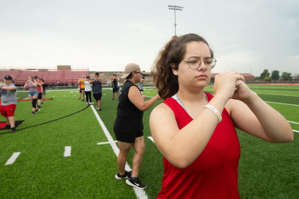 Cass Samples, a junior at Emporia High School, practices movements with fellow bandmates during an outdoor practice Thursday morning.