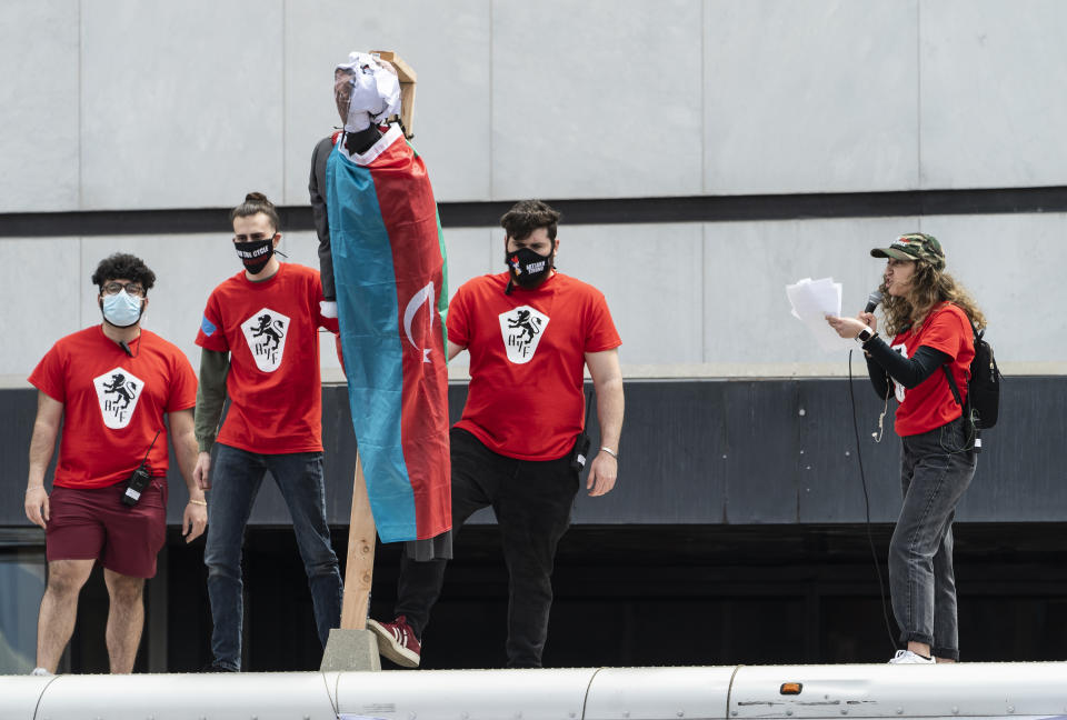 Protestors show a mannequin with the face of Turkish President Recep Tayyip Erdogan hanging on a wooden gallow set on top of a rental moving truck, as they hold a rally against the Armenian genocide in Beverly Hills, Calif., Saturday, April 24, 2021. The systematic killing and deportation of more than a million Armenians by Ottoman Empire forces in the early 20th century was "genocide," the United States formally declared on Saturday, as President Joe Biden used that precise word after the White House had avoided it for decades for fear of alienating ally Turkey. (AP Photo/Damian Dovarganes)