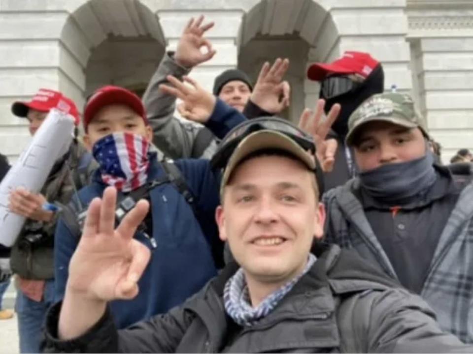 Accused Philadelphia Proud Boys leader Zachary Rehl flash hand signals associated with the white power movement in front of the Capitol on Jan. 6, 2021.