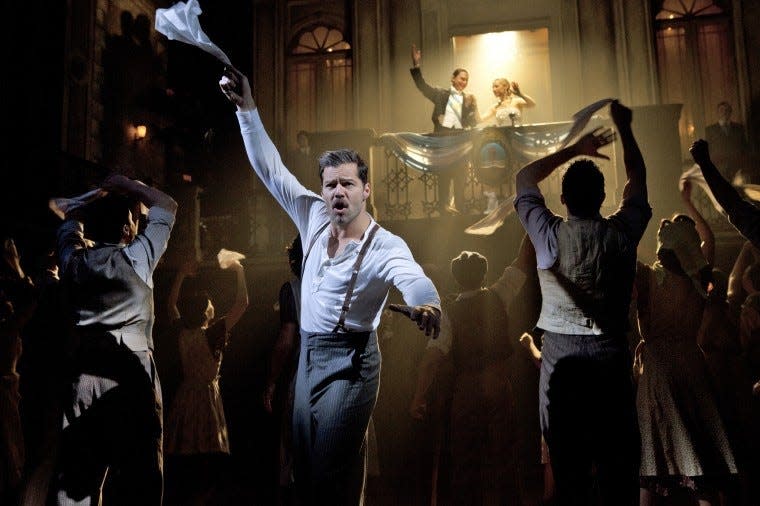 Ricky Martin (foreground) stars with Michael Cerveris and Elena Roger in “Evita” at the Marquis Theatre.