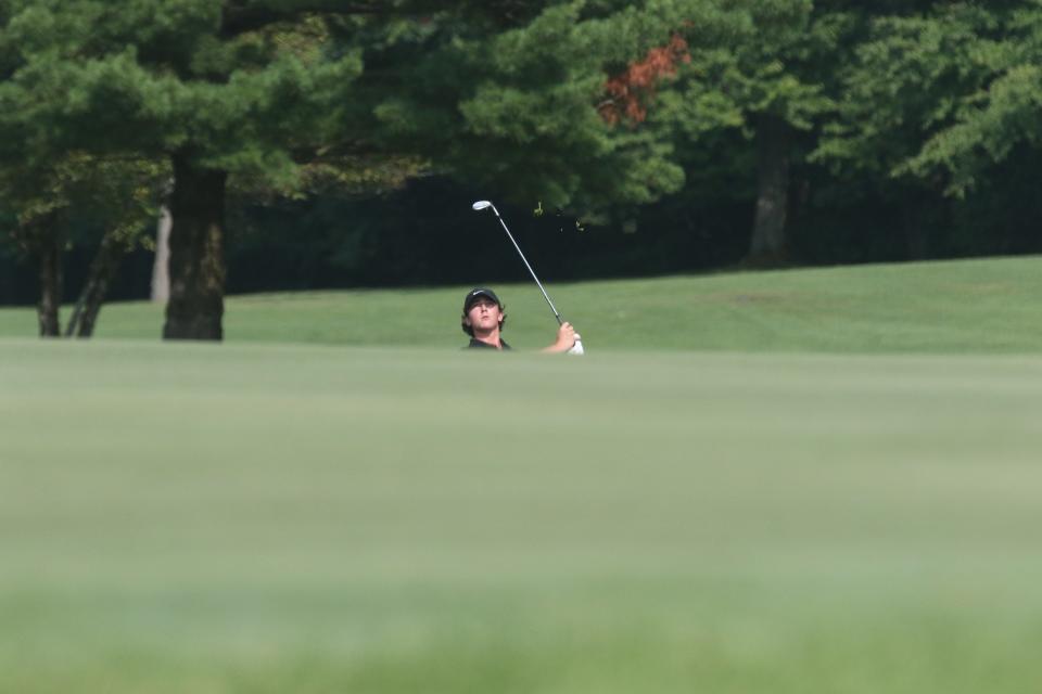 Shelby's Ashton Hoffbauer watched as his approach shot flies toward the green on No.  12 at Twin Lakes Gold Course Monday morning.