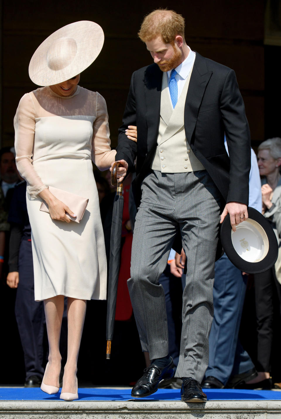 Meghan’s pale tights, worn to Prince Charles’ 70th birthday party on May 22, sparked plenty of conversation [Photo: Rex]