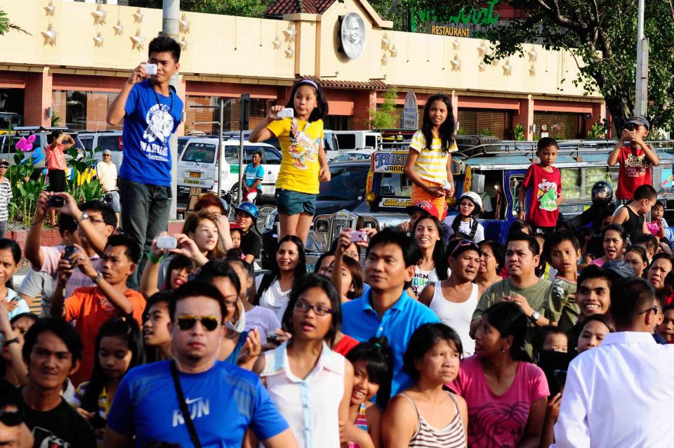 Spectators take photos of their favorite actresses and actors during the 2012 Metro Manila Film Festival Parade of Stars on 23 December 2012.(Angela Galia/NPPA Images)