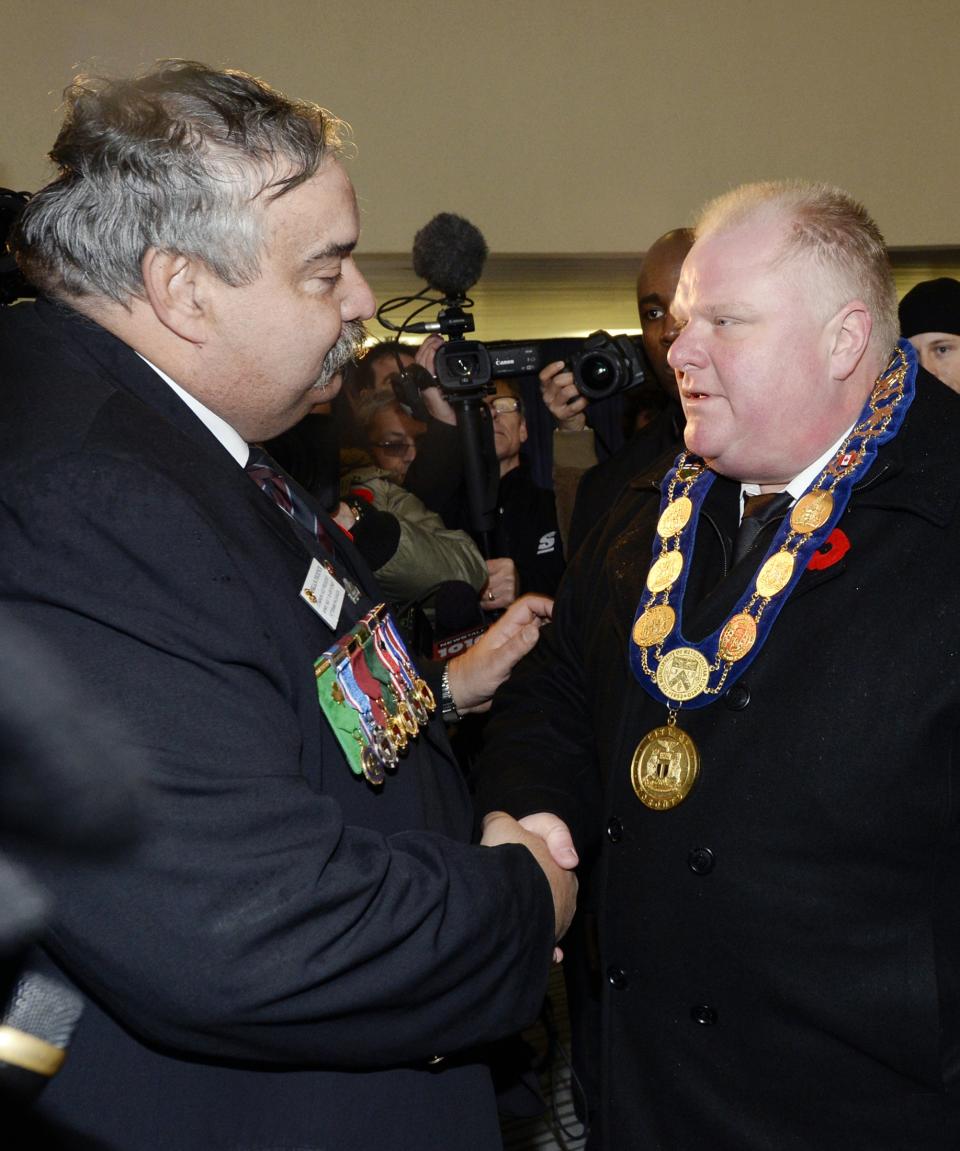 Toronto Mayor Ford shakes hands with an unidentified man at City Hall following Remembrance Day ceremonies at Old City Hall in Toronto