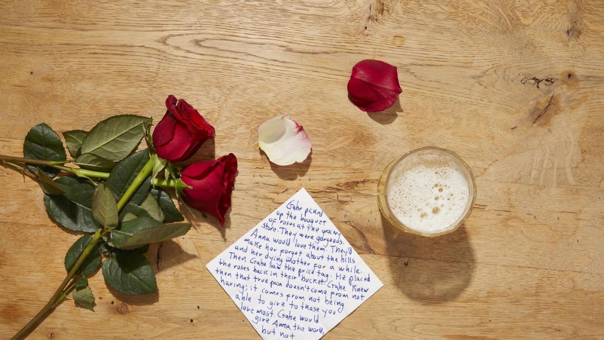 a note and flowers on a table