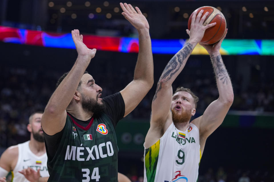 Lithuania forward Ignas Brazdeikis (9) shoots over Mexico center Joshua Ibarra (34) during the first half of a Basketball World Cup group D match in Manila, Philippines Sunday, Aug. 27, 2023. (AP Photo/Michael Conroy)