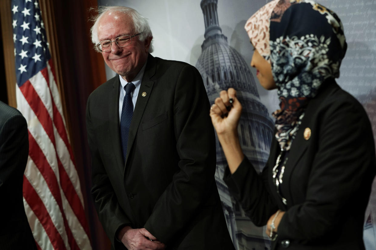 Sen. Bernie Sanders, I-Vt., smiles at Rep. Ilhan Omar, D-Minn., during a news conference on prescription drug pricing in Washington, D.C., in January. (Photo by Alex Wong/Getty Images)