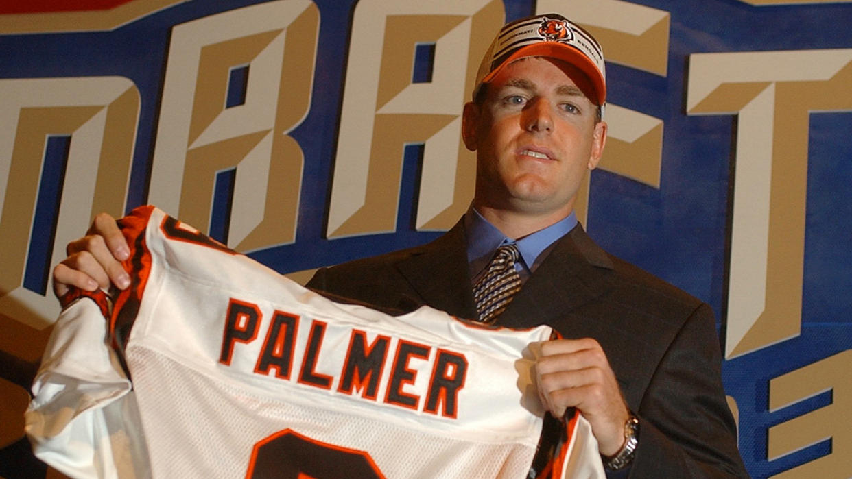 Mandatory Credit: Photo by Ed Betz/AP/Shutterstock (6032801b)PALMER Carson Palmer, a quarterback from Southern Cal, holds up a Cincinnati Bengals jersey after they selected him as the No.
