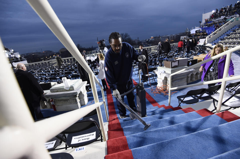 <p>A worker cleans steps on the inaugural stand on Capitol Hill in Washington, Friday, Jan. 20, 2017, before the inauguration of Donald Trump as the 45th president of the United States. (Photo: Saul Loeb via AP, Pool) </p>