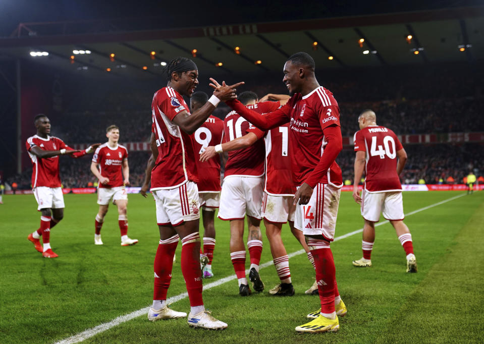Nottingham Forest's Callum Hudson-Odoi, right, celebrates with team-mate Anthony Elanga after scoring their side's second goal of the game during the English Premier League soccer match between Newcastle United and Nottingham Forest at the City Ground in Nottingham, Saturday Feb. 10, 2024. (Bradley Collyer/PA via AP)