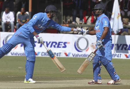 Indian batsman Ambati Rayudu (R) is congratulated by team mate Axar Patel during their first One Day International cricket match against Zimbabwe in Harare, July 10, 2015. REUTERS/Philimon Bulawayo