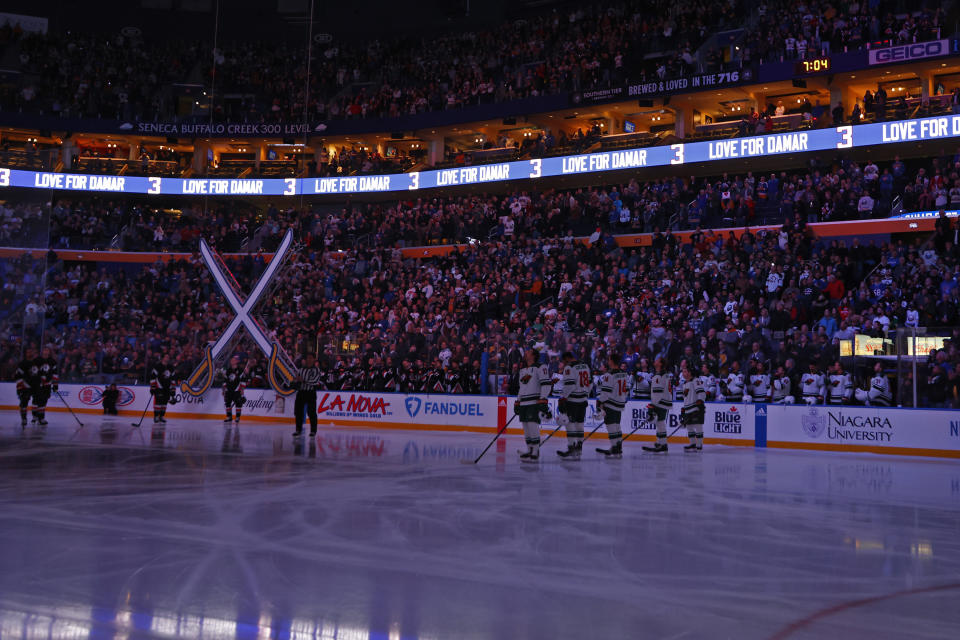 Players pay tribute to Buffalo Bills safety Damar Hamlin prior to an NHL hockey game between the Buffalo Sabres and the Minnesota Wild, Saturday, Jan. 7, 2023, in Buffalo, N.Y. (AP Photo/Jeffrey T. Barnes)