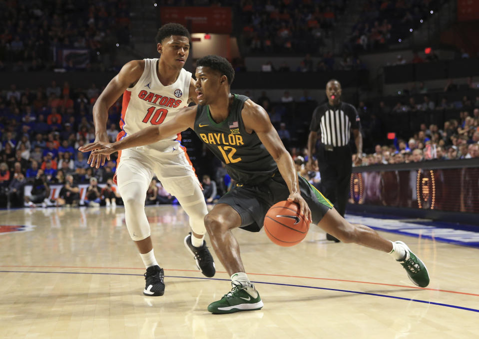 Baylor guard Jared Butler (12) drives around Florida guard Noah Locke (10) during the second half of an NCAA college basketball game Saturday, Jan. 25, 2020, in Gainesville, Fla. (AP Photo/Matt Stamey)