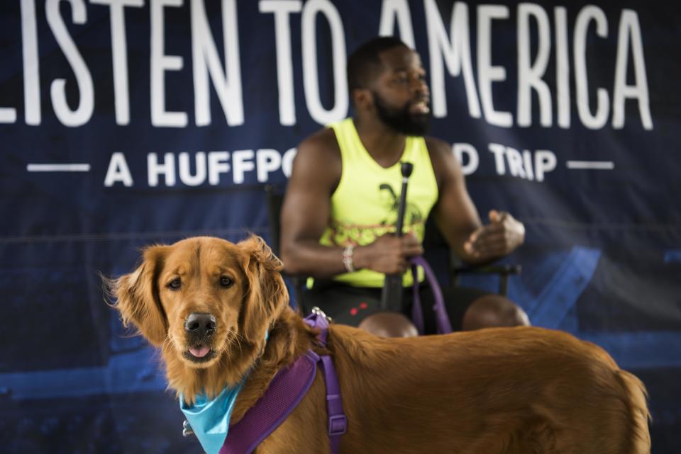 Richard Dixon is interviewed while his dog waits.