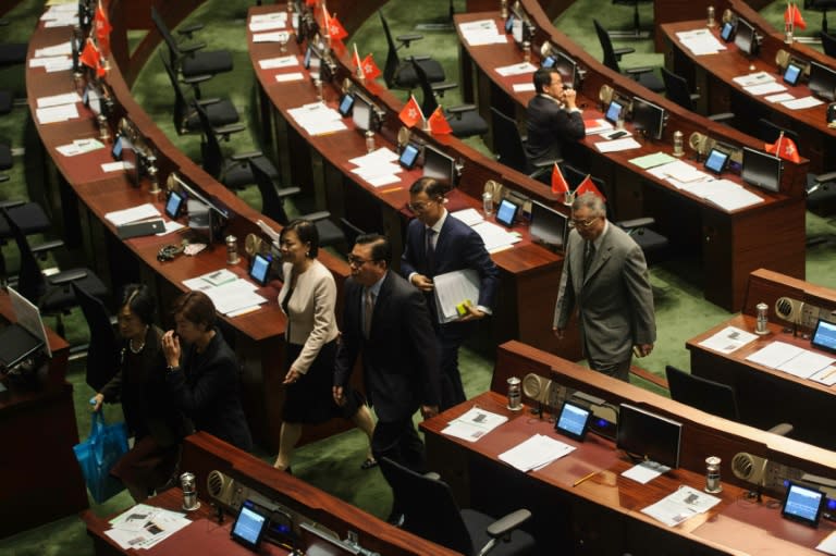 Pro-Beijing legislators walk out of the Legislative Council in Hong Kong to block the second swearing-in of pro-independence lawmakers on October 19, 2016