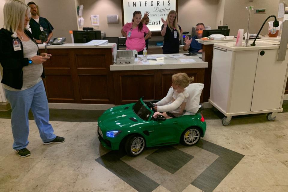 Paetyn pictured driving around the hospital in a toy car. (GoFundMe)