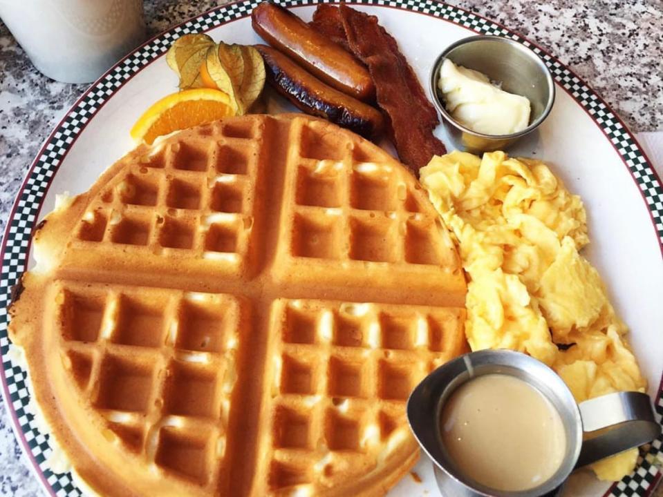 plate of waffle, eggs, sausage, bacon, and toppings from john's place in victoria ca