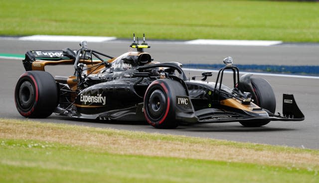 A black F1 car on the track