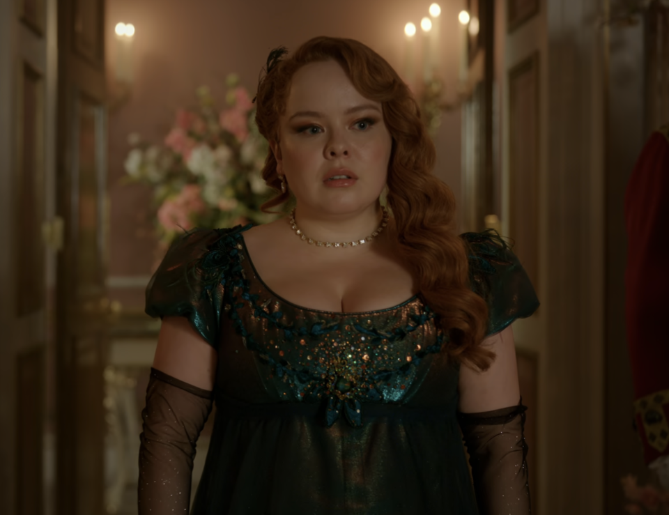 Penelope in period costume with beaded dress, gloves, and pearl necklace