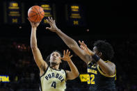 Purdue forward Trey Kaufman-Renn (4) shoots over Michigan forward Tarris Reed Jr. (32) during the first half of an NCAA college basketball game in Ann Arbor, Mich., Thursday, Jan. 26, 2023. (AP Photo/Paul Sancya)