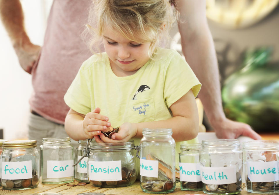 Child putting money into jars