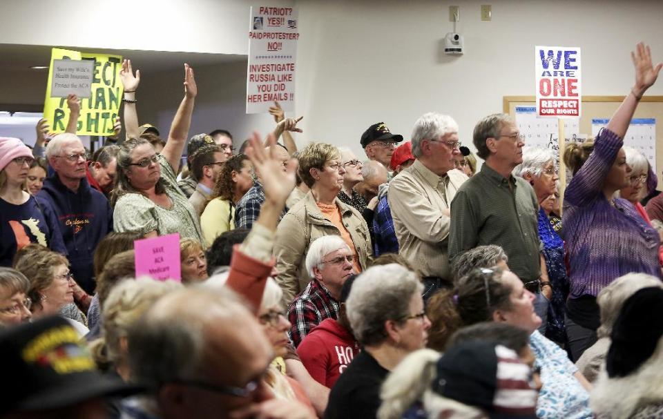 Attendees wait to pose questions to Sen. Joni Ernst, R-Iowa, during a veterans roundtable event at Maquoketa City Hall on Tuesday, Feb. 21, 2017, in Maquoketa, Iowa. Iowa’s U.S. senators were met Tuesday with overflow crowds who pointedly questioned them about President Donald Trump’s actions during his first month in office and other issues. Although Republican Sens. Charles Grassley and Ernst held meetings in small towns in northern and eastern Iowa, they drew big crowds. (Nicki Kohl/Telegraph Herald via AP)