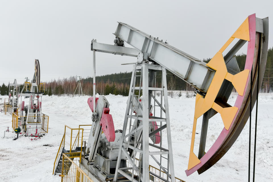 An oil derrick in a snowy landscape.