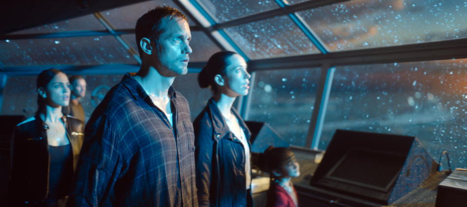 Alexander Skarsgård and Rebecca Hall stare in shock at the arrival of Godzilla