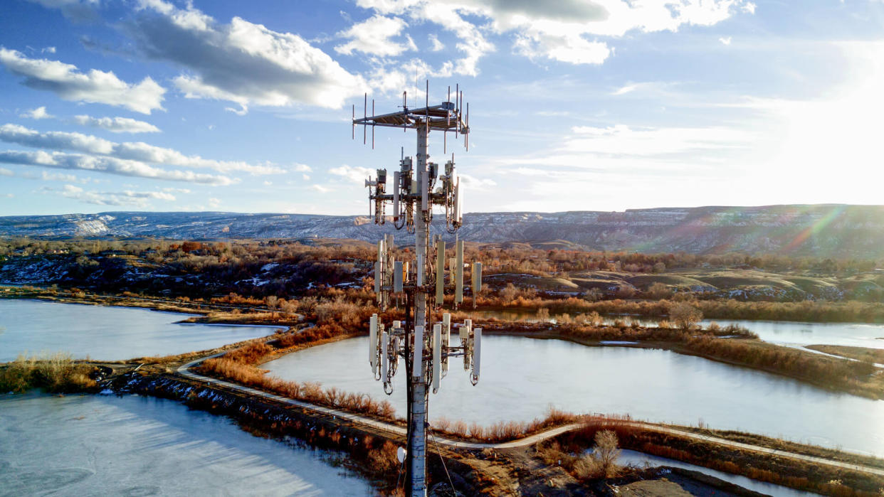 Beautiful shot of a modern cellular phone tower in a pretty setting with beautiful clouds.