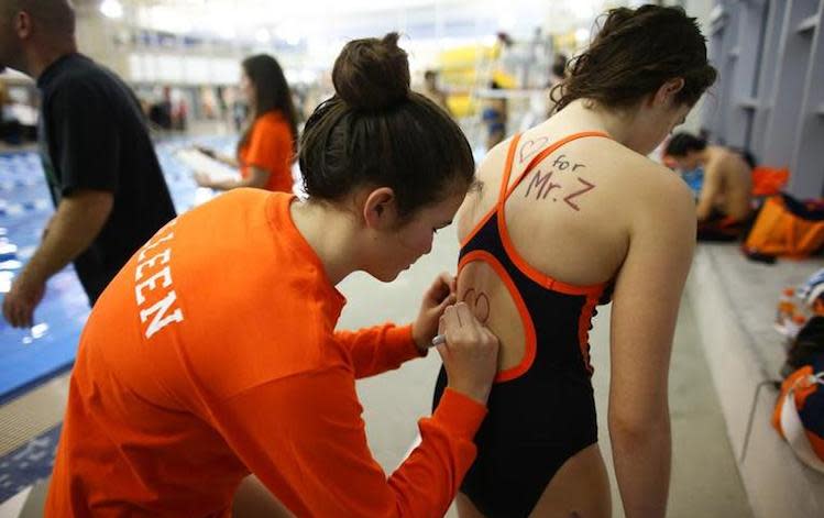 Eastside Catholic High swimmers pledge their support to recently fired coach Mark Zmuda -- Associated Press
