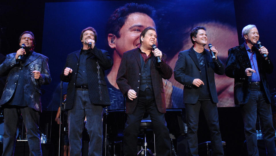 The Osmonds perform during their 50th anniversary tour at Wembley Arena in 2008 (Credit: Samir Hussein/Getty Images)
