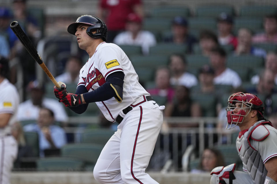 Atlanta Braves' Austin Riley watches his two-run home run next to Philadelphia Phillies catcher J.T. Realmuto during the first inning of a baseball game Thursday, May 25, 2023, in Atlanta. (AP Photo/John Bazemore)