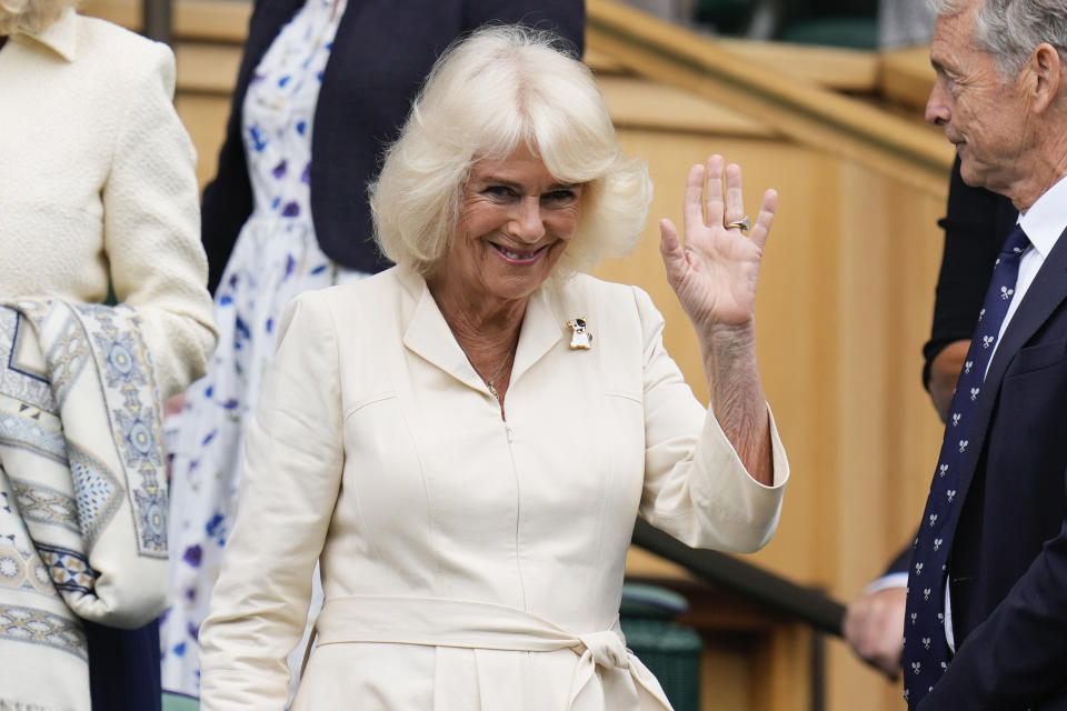 Britain's Queen Camilla waves as she arrives on Centre Court ahead of the quarterfinal match Elena Rybakina of Kazakhstan and Elina Svitolina of Ukraine at the Wimbledon tennis championships in London, Wednesday, July 10, 2024. (AP Photo/Kirsty Wigglesworth)