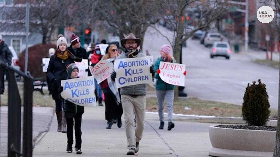 People hold sign for anti-abortion advocacy.