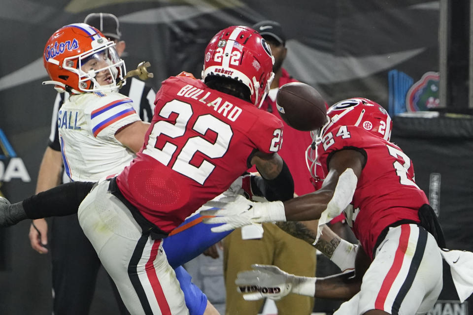 Georgia defensive backs Javon Bullard (22) and Malaki Starks (24) break up a pass intended for Florida wide receiver Ricky Pearsall, left, during the second half of an NCAA college football game Saturday, Oct. 29, 2022, in Jacksonville, Fla. (AP Photo/John Raoux)