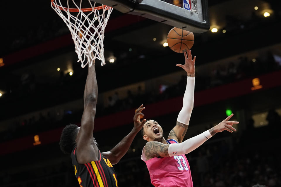 Washington Wizards forward Kyle Kuzma (33) shoots as Atlanta Hawks guard Garrison Mathews (25) defends during the first half of an NBA basketball game Tuesday, Feb. 28, 2023, in Atlanta. (AP Photo/John Bazemore)