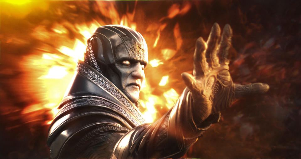 Oscar Isaac, portraying Apocalypse, extends a hand with a fierce expression in a scene from "X-Men: Apocalypse."