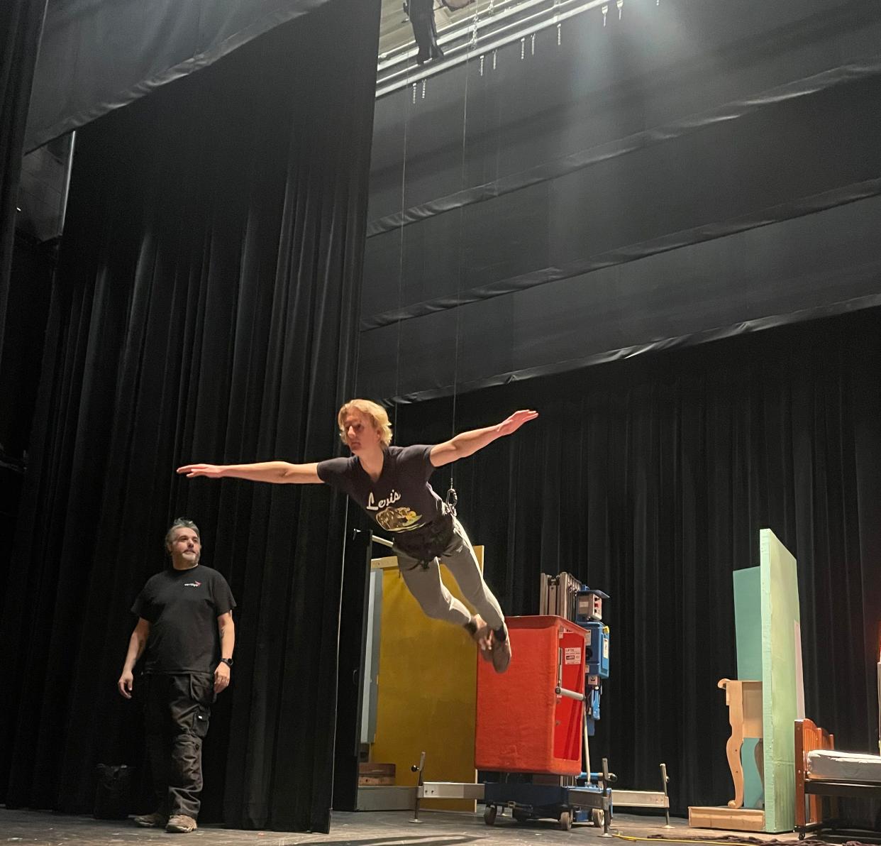 A Plymouth High School student practices flying on stage in preparation for the annual musical, which will be 'Mary Poppins.'