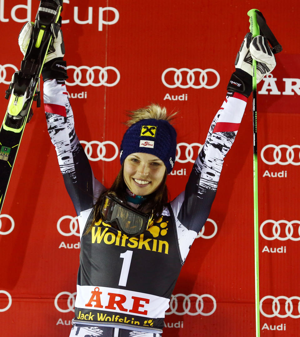 Austria's Anna Fenninger celebrates on the podium after winning an alpine ski women's World Cup giant slalom, in Are, Sweden, Friday, March 7, 2014. (AP Photo/Alessandro Trovati)