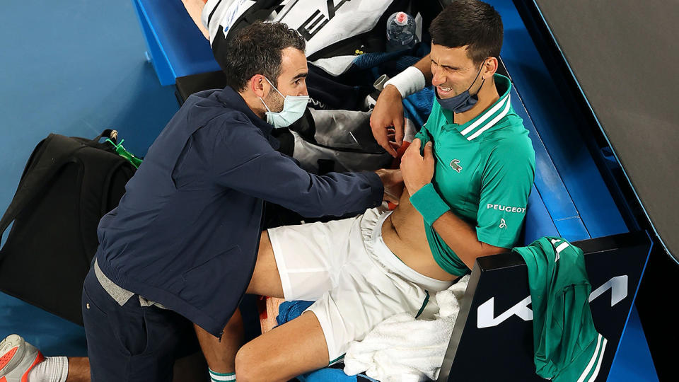 Novak Djokovic, pictured here during a medical timeout against Taylor Fritz at the Australian Open.