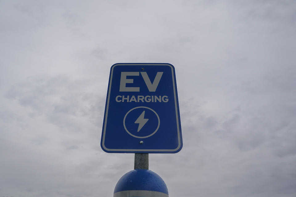 A sign sits at an electric vehicle charging station, Friday, March 8, 2024, at an electric vehicle charging station in London, Ohio. The charging ports are a key part of President Joe Biden’s effort to encourage drivers to move away from gasoline-powered cars and trucks that contribute to global warming. (AP Photo/Joshua A. Bickel)