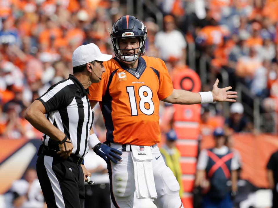 Peyton Manning talks with a referee after a play in 2015.