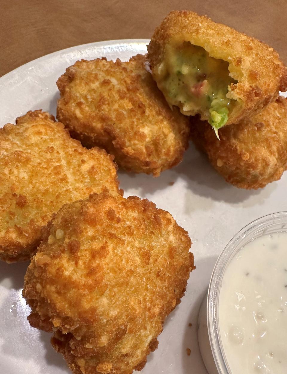 Broccoli cheddar poofs are a veggie-and-cheese-forward appetizer with golden breading available at The College Inn in Alliance.