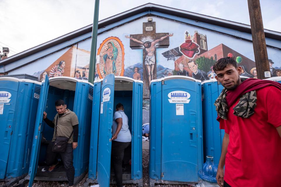 Migrants use portable bathrooms at Sacred Heart church on May 3, 2023. Hundreds of migrants are seeking refuge at the church in Downtown El Paso. 