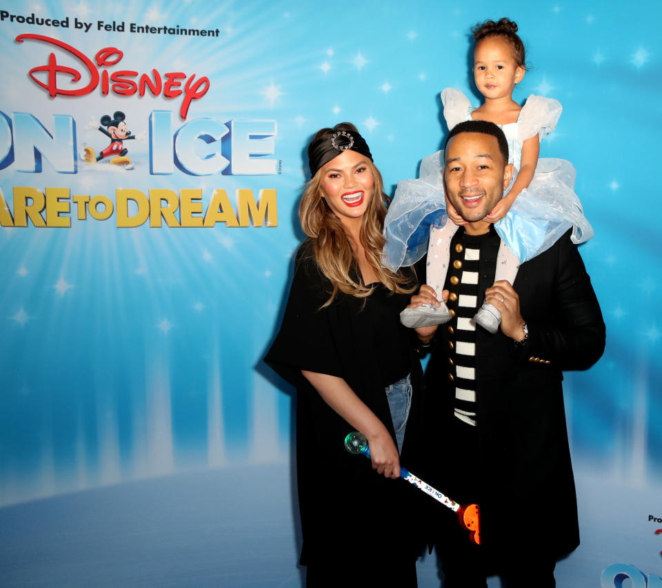 LOS ANGELES, CALIFORNIA – DECEMBER 14: Chrissy Teigen, John Legend and daughter Luna attend the Disney On Ice Presents Dare to Dream Celebrity Skate Party at Staples Center on December 14, 2018 in Los Angeles, California.  (Photo by Ari Perilstein/Getty Images for Feld Entertainment, Inc.)