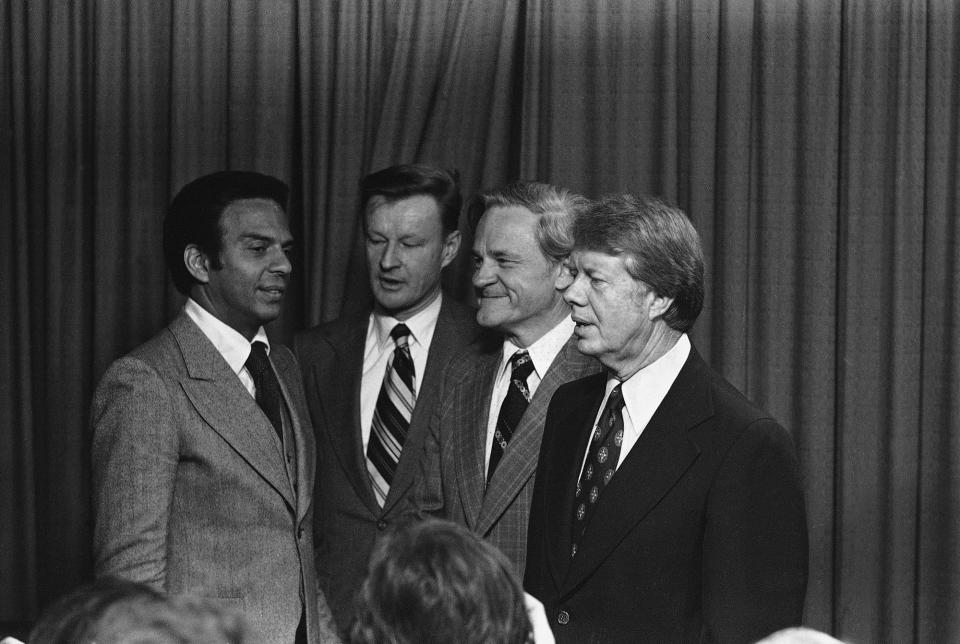 <p>President-elect Jimmy Carter talks with his new appointees after they were named during a news conference in Plains, Ga., on Thursday Dec. 17, 1976. They are from left: Rep. Andrew Young (D.Ga.) to be U.N Ambassador; Zbigniew Brzezinski, head of the National Security Council; Charles Schultze, Chairman of the Economic Advisors council. (Photo: AP) </p>